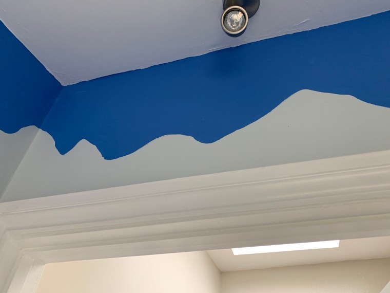 blue paint beginning to reveal mountains