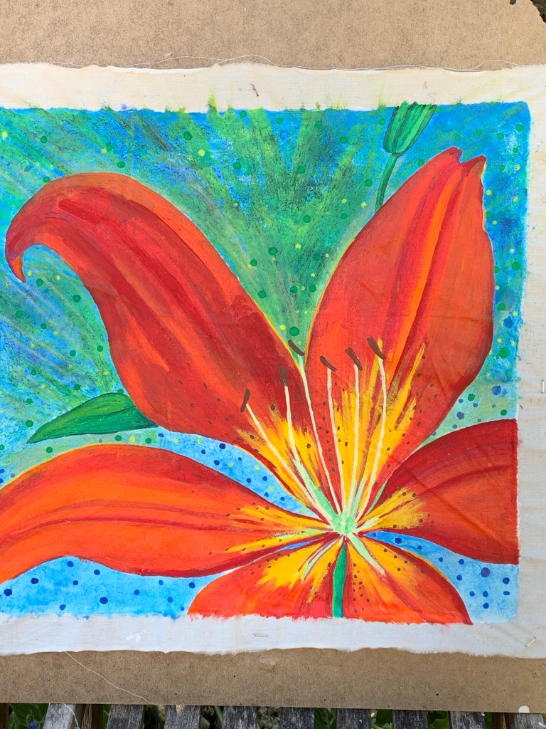 Beauty of flaming lily flower against blue summer sky